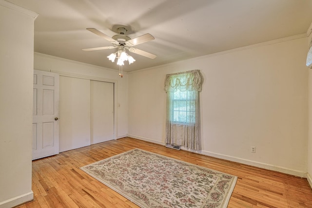 104 Pine, Laurens, SC 29360 - unfurnished bedroom with light wood-style floors, a closet, crown molding, and ceiling fan