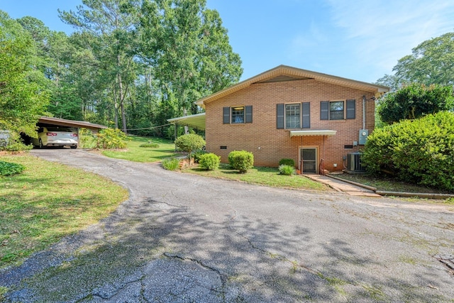 104 Pine, Laurens, SC 29360 - view of side of property with brick siding, asphalt driveway, and a yard