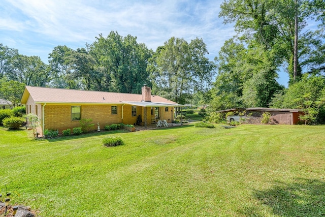 104 Pine, Laurens, SC 29360 - back of property featuring a chimney, a yard, and brick siding
