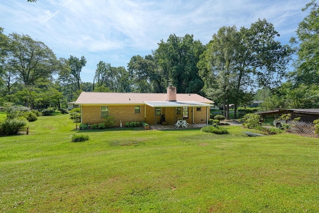 104 Pine, Laurens, SC 29360 - rear view of property featuring a chimney, a yard, and brick siding