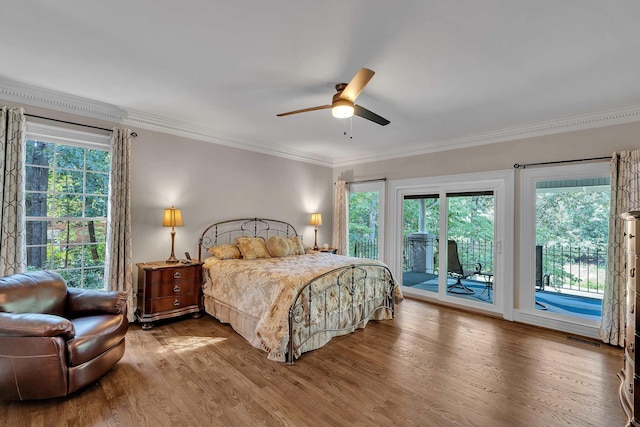 207 Carolina Club Dr, Spartanburg, SC 29306 - bedroom featuring access to outside, crown molding, wood finished floors, multiple windows, and a ceiling fan