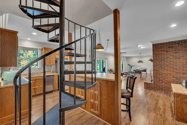 207 Carolina Club Dr, Spartanburg, SC 29306 - staircase featuring wood finished floors, recessed lighting, ornamental molding, and brick wall