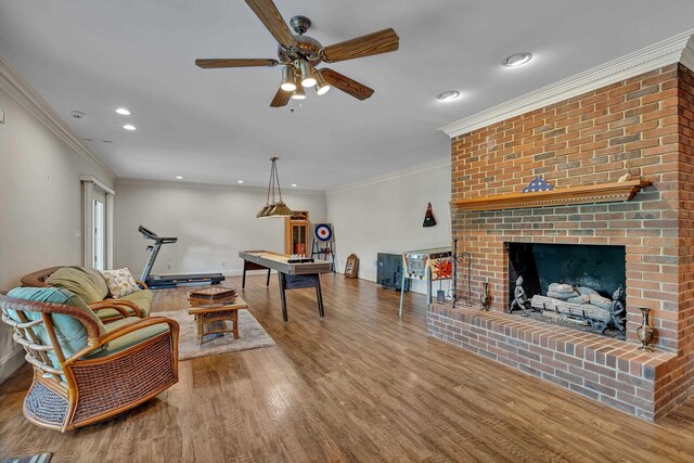 207 Carolina Club Dr, Spartanburg, SC 29306 - living room featuring ceiling fan, recessed lighting, wood finished floors, a brick fireplace, and crown molding