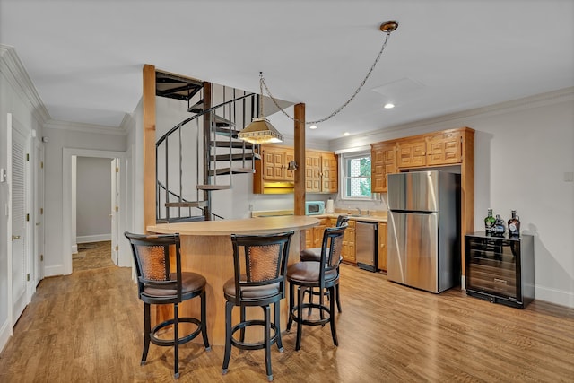 207 Carolina Club Dr, Spartanburg, SC 29306 - kitchen with appliances with stainless steel finishes, wine cooler, crown molding, a breakfast bar, and light wood-style floors