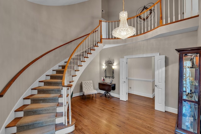 207 Carolina Club Dr, Spartanburg, SC 29306 - stairs featuring a high ceiling, a chandelier, and wood finished floors