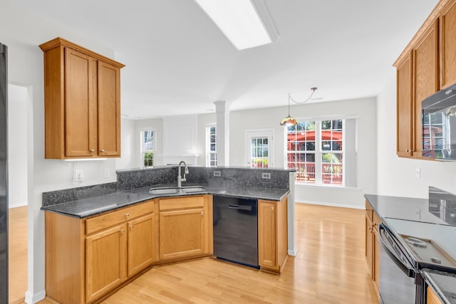 8 Glenbow, Simpsonville, SC 29680 - kitchen featuring black appliances, light wood finished floors, dark stone countertops, a peninsula, and brown cabinetry