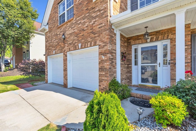 8 Glenbow, Simpsonville, SC 29680 - doorway to property featuring an attached garage, concrete driveway, and brick siding