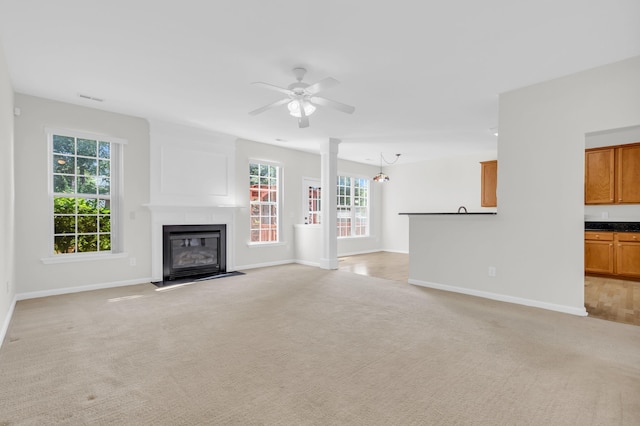 8 Glenbow, Simpsonville, SC 29680 - unfurnished living room with a fireplace with flush hearth, ceiling fan, and light carpet
