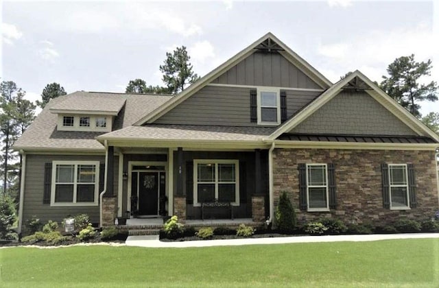 craftsman-style home with a porch and a front yard