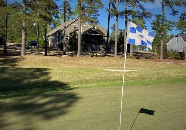 view of home's community with a yard