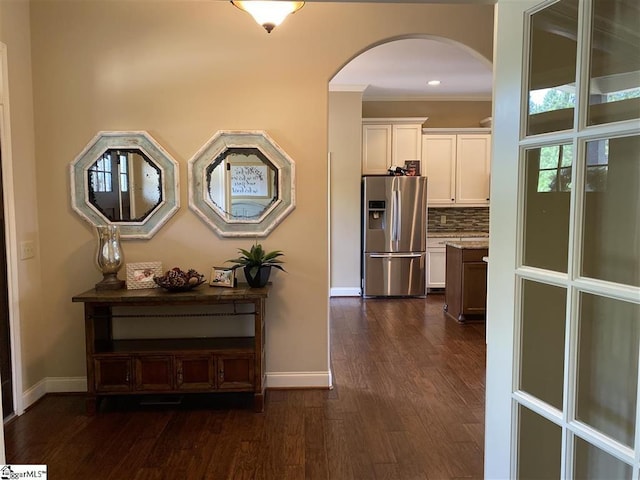 corridor featuring dark hardwood / wood-style flooring and ornamental molding