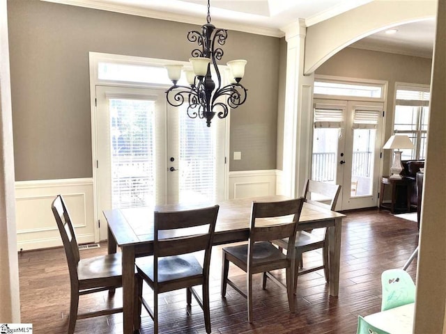 dining area featuring a chandelier, french doors, crown molding, and dark hardwood / wood-style floors