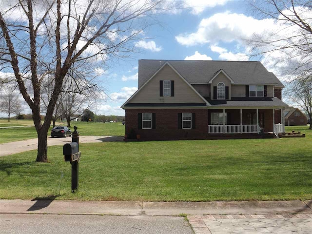 view of front of house with covered porch and a front yard