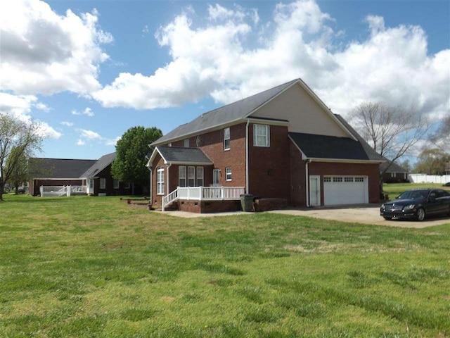 exterior space with a yard, covered porch, and a garage