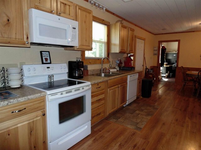 kitchen with crown molding, light brown cabinetry, dark tile flooring, sink, and white appliances