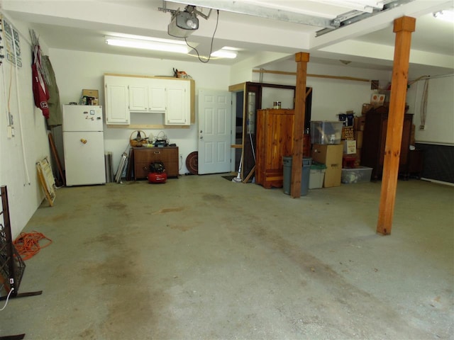 garage with white fridge and a garage door opener