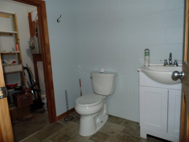 bathroom with vanity, tile floors, and toilet