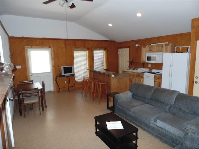 living room featuring vaulted ceiling, ceiling fan, and sink