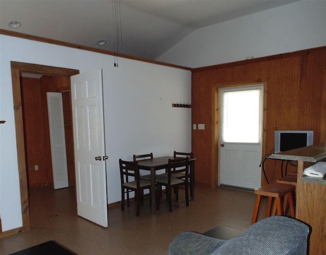 dining space featuring vaulted ceiling