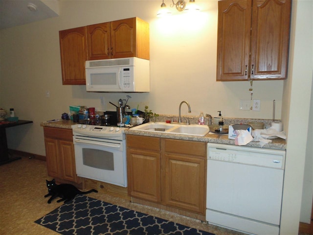 kitchen featuring white appliances and sink