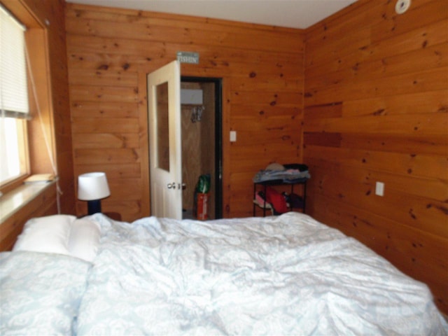 bedroom featuring wood walls