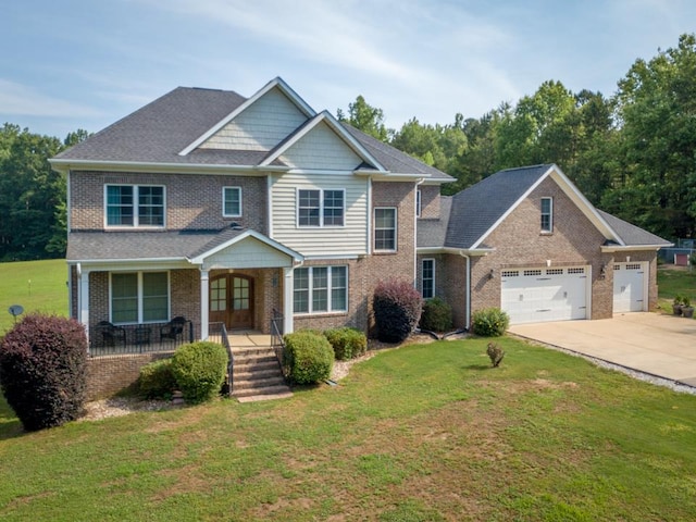 view of front of home featuring covered porch, a front lawn, and a garage