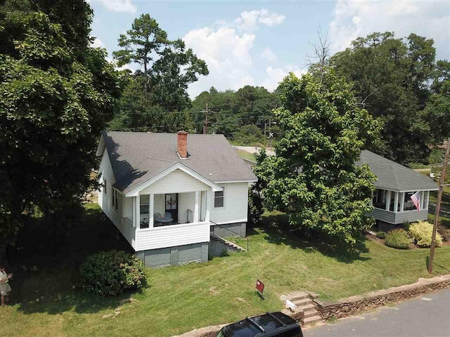 view of front of house with a porch and a front lawn