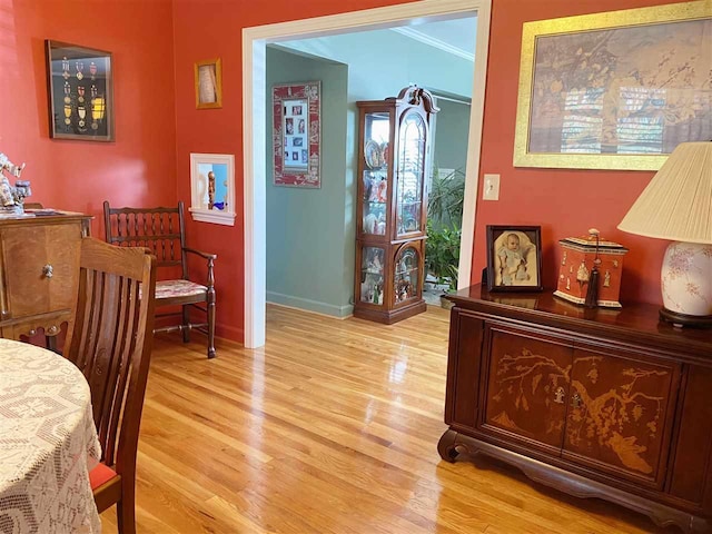 bedroom with crown molding and light hardwood / wood-style floors