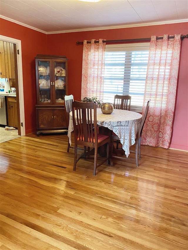 dining room featuring crown molding and light wood-type flooring