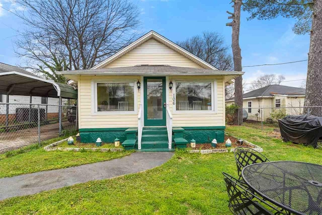 bungalow-style home with a front yard and a carport