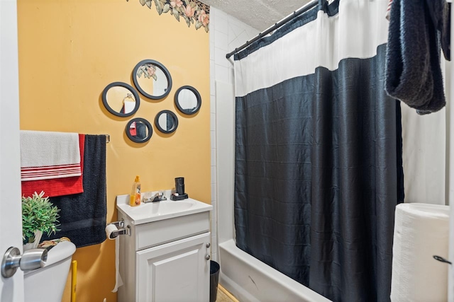 full bathroom featuring a textured ceiling, toilet, vanity, and shower / tub combo with curtain