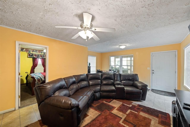 living room featuring light tile floors, a textured ceiling, and ceiling fan