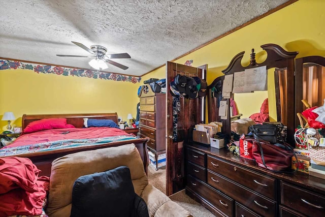 bedroom with ceiling fan, light colored carpet, and a textured ceiling