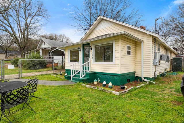 back of house featuring a lawn