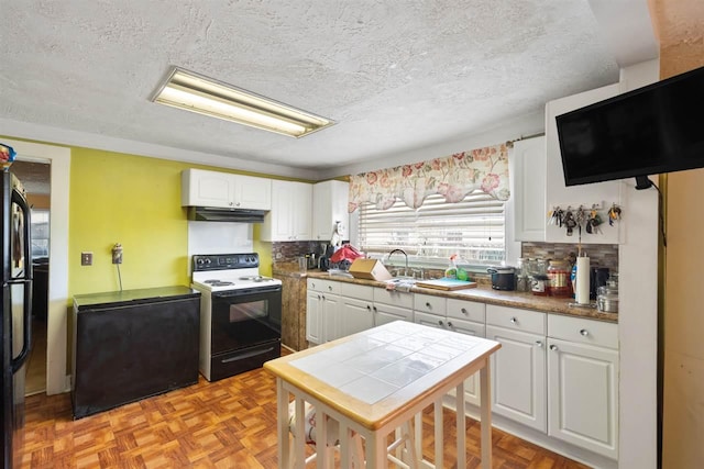 kitchen featuring light parquet flooring, white cabinets, a textured ceiling, and white electric stove