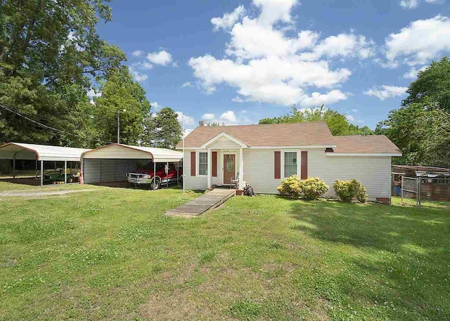 view of front of home with a carport and a front yard