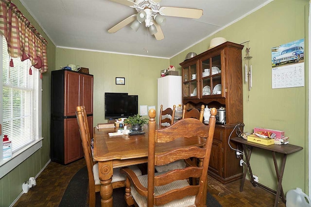 dining area with ceiling fan, dark parquet floors, and ornamental molding