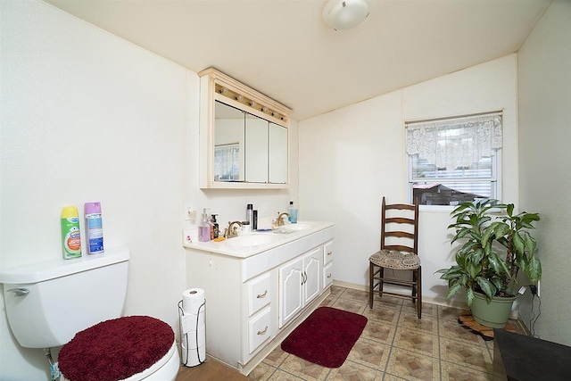 bathroom with tile floors, toilet, and vanity