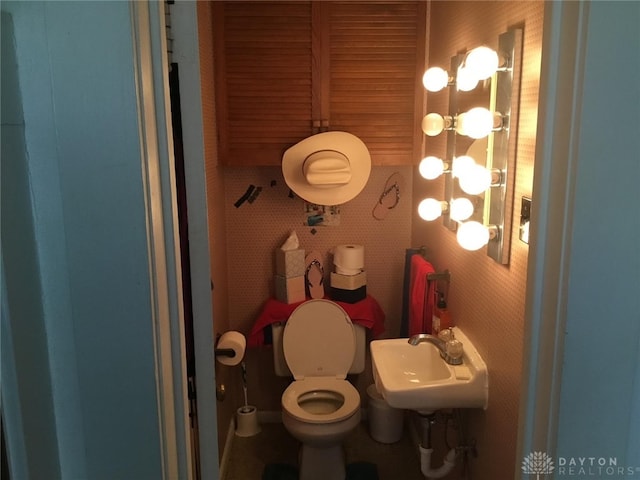 bathroom featuring sink and toilet