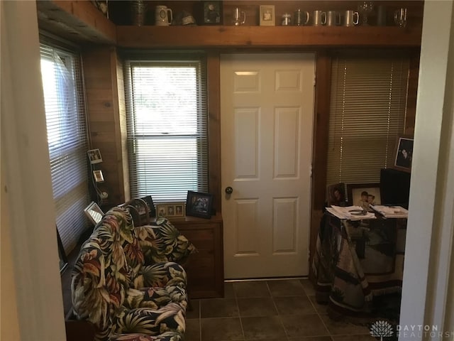 doorway to outside with dark tile patterned floors