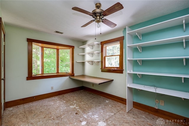 interior space with ceiling fan and light tile patterned floors