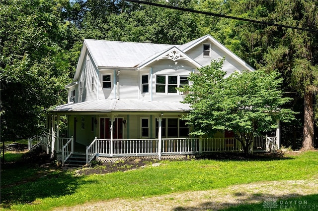 view of front of home featuring covered porch and a front yard