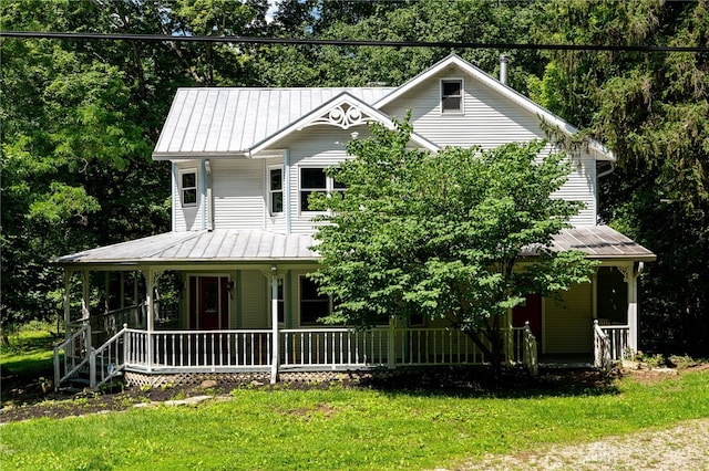 farmhouse inspired home with a porch and a front lawn