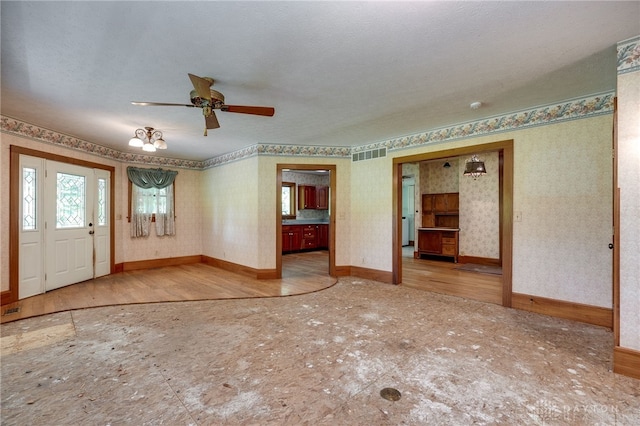 entrance foyer featuring a textured ceiling, ceiling fan, and wood-type flooring