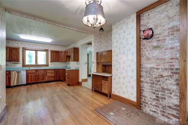 kitchen featuring a notable chandelier, light wood-type flooring, sink, dishwasher, and a textured ceiling