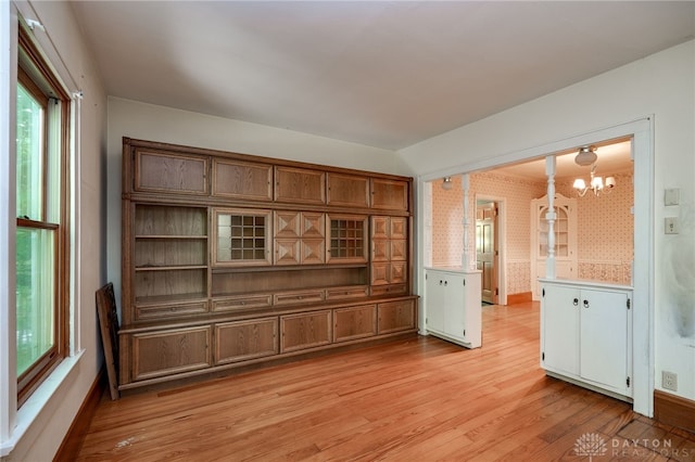 interior space featuring a notable chandelier and light hardwood / wood-style flooring