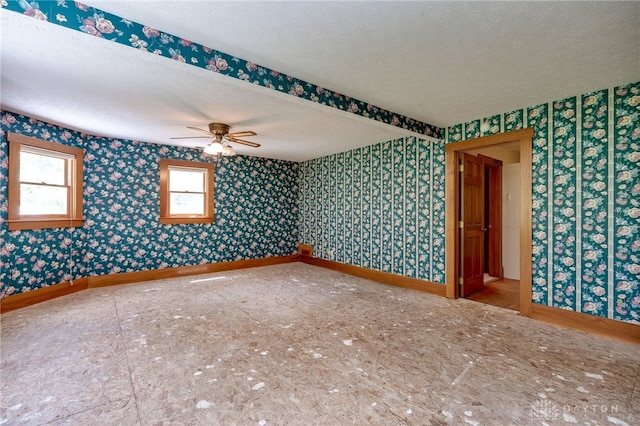 unfurnished room featuring a textured ceiling and ceiling fan