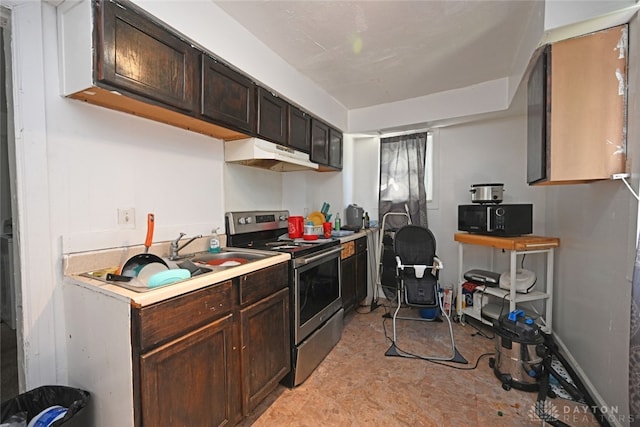 kitchen with stainless steel range, light tile patterned flooring, custom range hood, and dark brown cabinetry