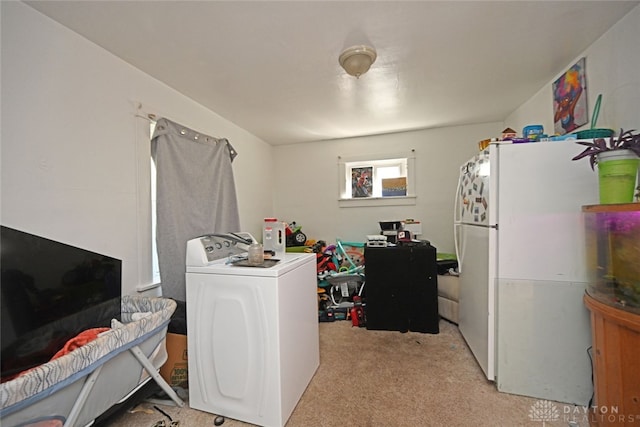 laundry room featuring washer / clothes dryer and light colored carpet