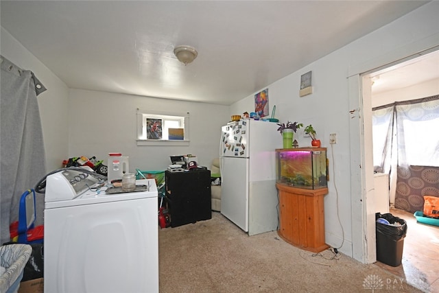 clothes washing area featuring separate washer and dryer and light carpet